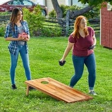Two Women Playing Cornhole