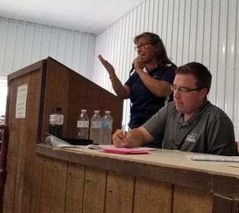 A Person Speaking Into A Microphone